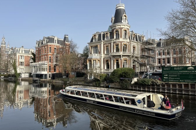 A glass-topped canal cruise boat on an Amsterdam canal