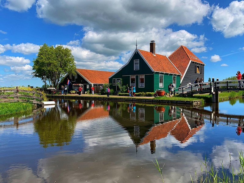 The green timber houses of Zaanse Schans reflected in the water