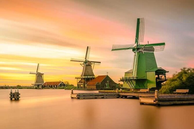 The working windmills of Zaanse Schans along the river at sunset